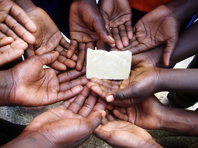 holding Home Sweet Home in the hand palm of their hands